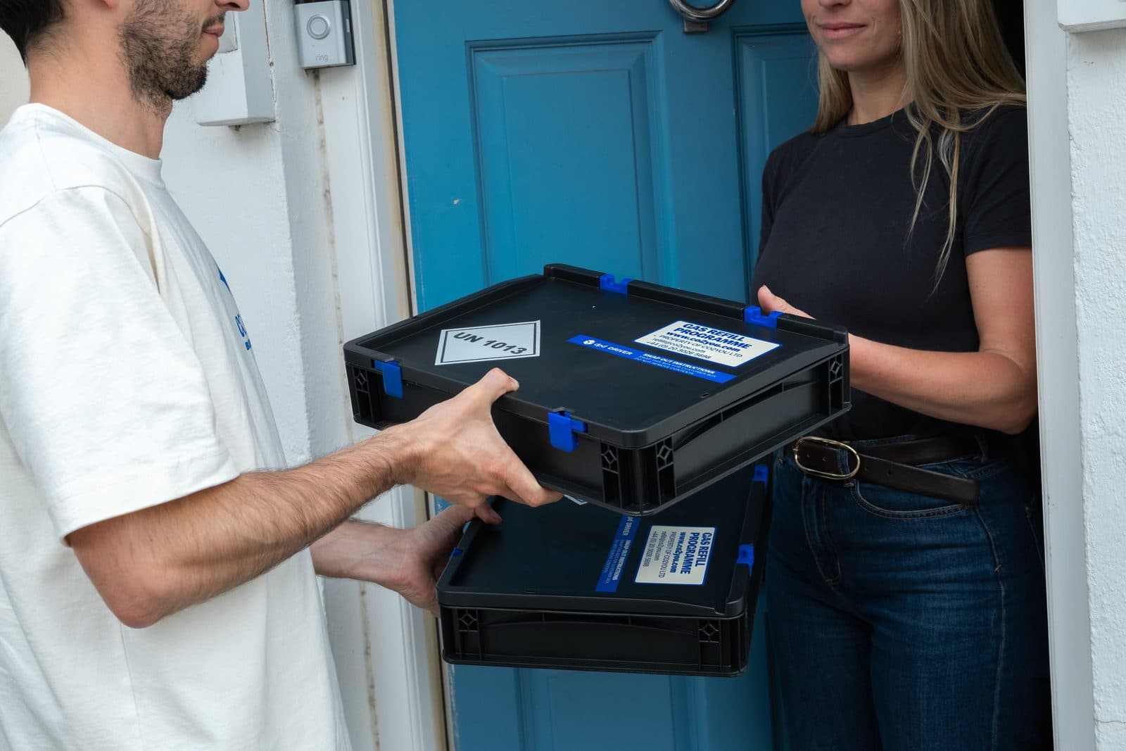 CO2 YOU driver swapping cylinder cases on the doorstep